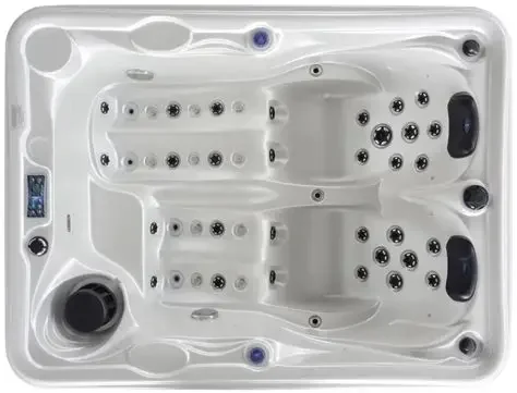 Cadă cu hidromasaj compactă HOME 210×160×77 cm cu un design alb, dotată cu mai multe jeturi de masaj, având două locuri pentru șezut și un panou de control pe margine.